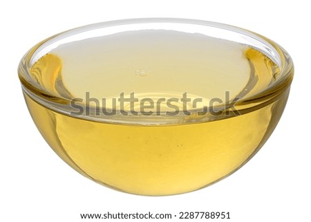 Agave syrup in a glass bowl isolated on white.