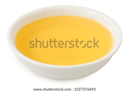 Agave syrup in a white ceramic bowl isolated on white.
