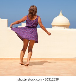 Age Doesn't Matter - Tanned, Fit Middle-aged Woman Dances On The Sunroof In Short Flared Dress