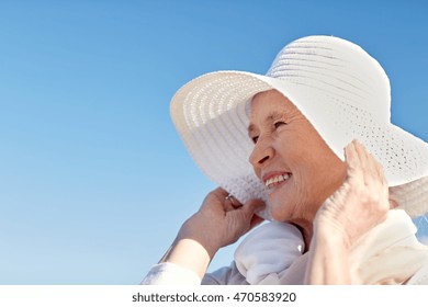 Age, Leisure And People Concept - Happy Senior Woman In Sun Hat On Summer Beach