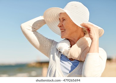 Age, Leisure, Travel, Tourism And People Concept - Happy Senior Woman In Sun Hat On Summer Beach