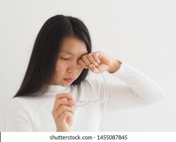 age related macular degeneration or eye vision disorder and eye syndrome in asian woman and wearing glasses, symptoms have itchy or scratch and suffering​.