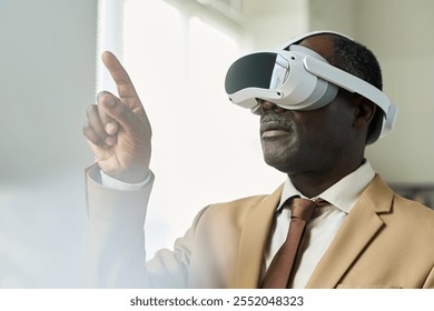 Aged African American businessman with virtual reality headset pointing at augmented visual board while making presentation - Powered by Shutterstock