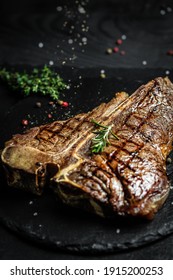 Aged Barbecue Porterhouse Steak. Beef T-Bone juicy steak Medium rare beef with spices on a black table, banner, catering menu recipe. - Shutterstock ID 1915200253