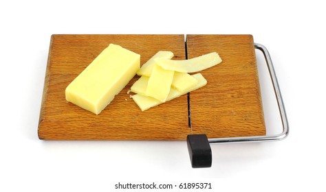 Aged Cheddar Cheese And Slices On A Cutting Board.