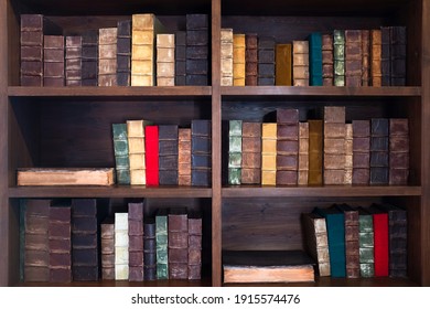 Aged classic books on wooden shelves
