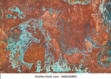 Aged copper plate texture with green patina stains. Old worn metal background. - Shutterstock ID 668636806