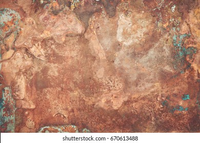 Aged copper plate texture with green patina stains. Old worn metal background.