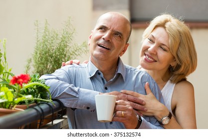 Aged couple drinking tea and chatting on balcony
 - Powered by Shutterstock