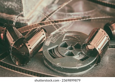 Aged dirty bobbin, movie rolls, retro reels, filmstrip, photographic film. Vintage dark background, retro style. Photo, movie cinema concept