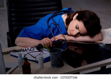 Aged Female Doctor Working At Night Shift 