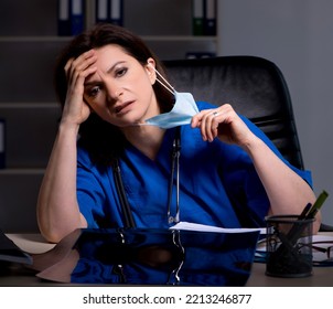 Aged Female Doctor Working At Night Shift