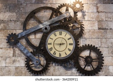 Aged gear clock on the brick wall
