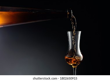 Aged Golden Fortified Wine From The Antique Bottle Being Poured Into A Crystal Glass. Copy Space.