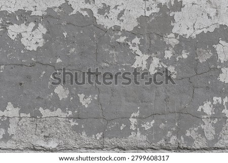 Aged gray cement wall with weathered plaster remnants