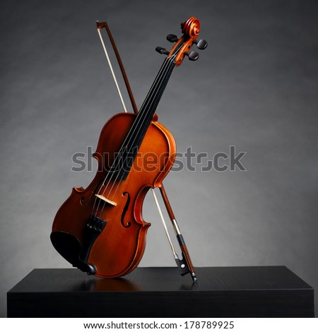 aged handmade violin on dark background