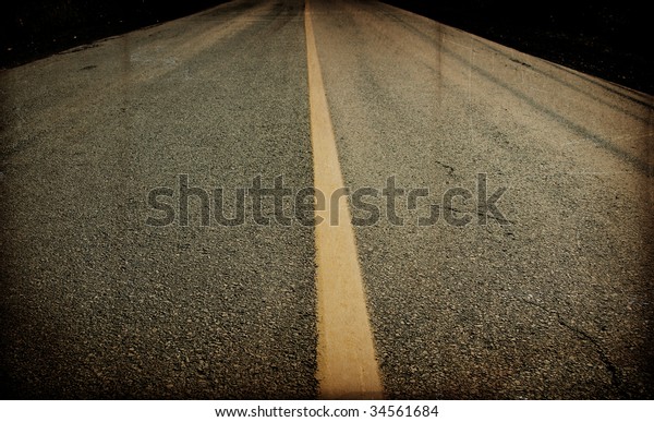 Aged image of a paved\
road
