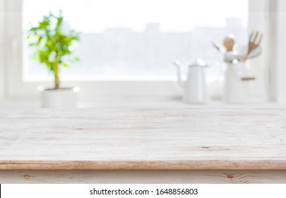 Aged kitchen table top over window background with copy space