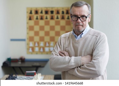 Aged Male Principal Of Chess Club Posing For Pictures For Advertising Chess Classes For Schoolchildren