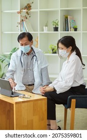 An Aged Male Therapist Talks And Diagnoses The Disease With A Female Patient. A Doctor And A Patient Discuss Treatment Options.