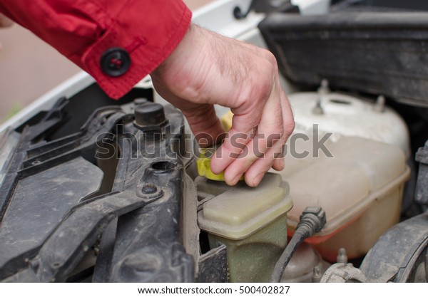 Aged man fixing the car
on the street