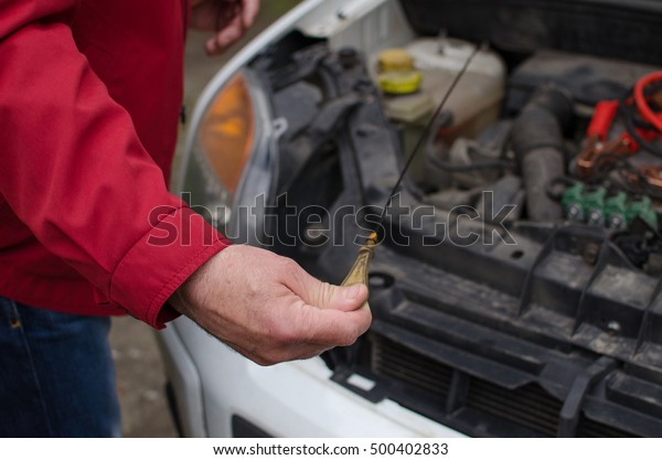 Aged man fixing the car\
on the street