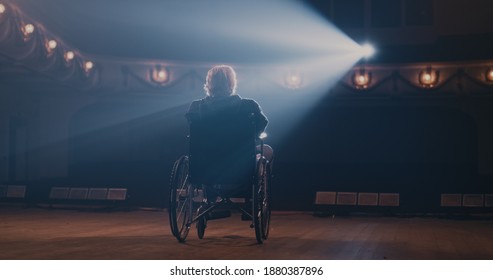 Aged man on wheelchair turning round and leaving stage in end of performance in theater - Powered by Shutterstock