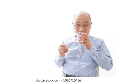 Aged Man Taking A Pill