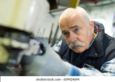 aged man working in an industrial factory - Powered by Shutterstock