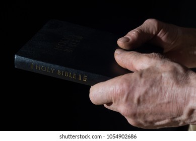 Aged Man's Hands Holding The Bible