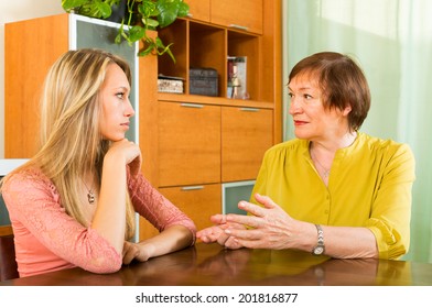 Aged Mother Having Serious Conversation With Adult Daughter  