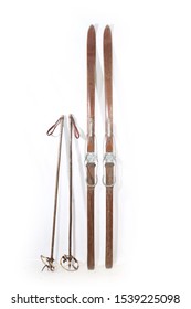 Aged Pair Of Wooden Ski And Poles On White Background