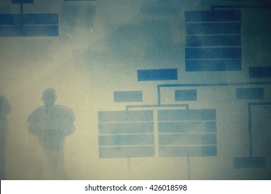 Aged pale silhouette shadows stamp on information visual board illustrated human power and organization chart