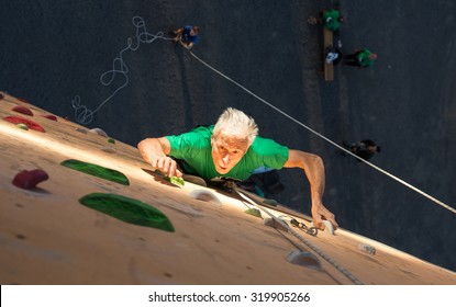 Aged Person Practicing Extreme Sport
Elderly Male Climber Makes Hard Move On Outdoor Climbing Wall Sport Competitions Very Emotional Face Highlighted With Spotlight Of Illumination