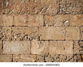Aged and rustic stone wall abstract texture brown orange background. Big stone brick wall texture. Weathered abrasion stone of old building. Ancient brick wall background. - Powered by Shutterstock - Get 15% off with code: PIKWIZARD15