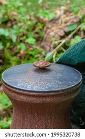 An aged and rusty chimnea in a garden