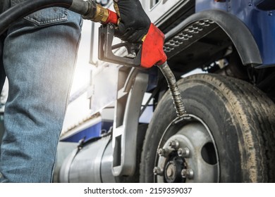 Aged Semi Truck Driver About To Refuel His Tractor Truck Holding Diesel Pump Nozzle In His Hand. Heavy Duty Transportation And Fuel Shortage Concept.