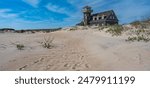 An aged structure by the sandy shore in Cape Hatteras National Seashore