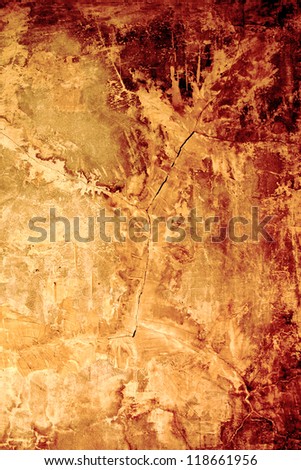 Aged, super-textured background with cracks in golden-rusty (autumn) colors. Faded area for copy space.