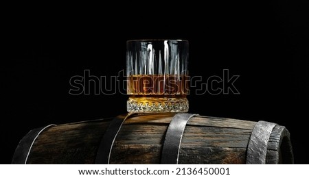 Aged and tasty whiskey on an oak barrel