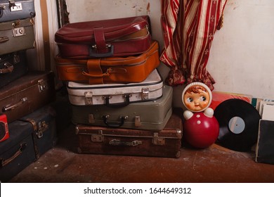 Aged Things In A Traditional Soviet Apartment. Retro Interior In Abandoned House. Outdated Furniture And Household Items. Suitcases And Toy Roly-poly From 1950s. Not Maintained Grandmother's Home