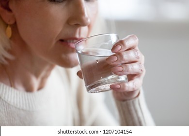 Aged Woman Holding Glass Feeling Thirsty Or Dehydrated, Senior Female Drinking Fresh Pure Aqua Following Healthy Lifestyle, Elderly Lady Having Still Mineral Water. Refreshment, Dehydration Concept