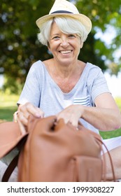 Aged Woman Looking Inside Her Bag