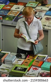 Aged Woman Reading A Book At Culture Festival Booth Turin Italy May 22 2022