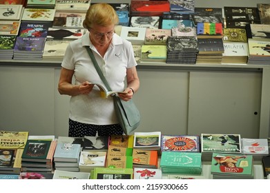 Aged Woman Reading A Book At Culture Festival Booth Turin Italy May 22 2022