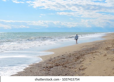aged woman walking near the sea