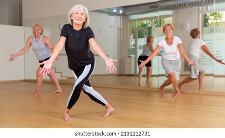 Aged Women Performing Modern Dance During Their Group Training In Fitness Room.