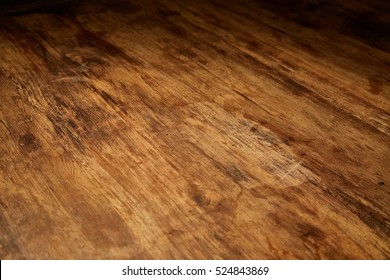 Aged wood desk in dim light