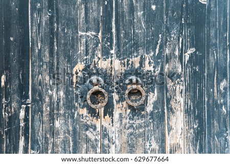 aged wooden door with traditional chinese knocker 