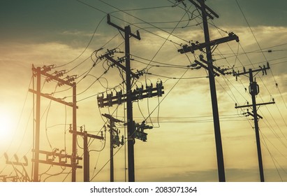 Aged Wooden Electric Poles And High Voltage Infrastructure. Power Industry Theme.